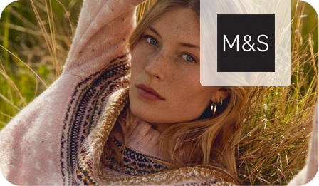 woman in pink jumper in field with m&s logo